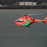 Buy canvas prints of Wales Air Ambulance over Swansea Bay by Jane Emery