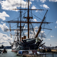 Buy canvas prints of HMS WARRIOR in PORTSMOUTH HARBOUR  by DAVE BRENCHLEY