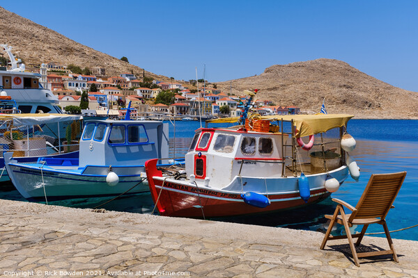 Halki Boats and Chair Picture Board by Rick Bowden