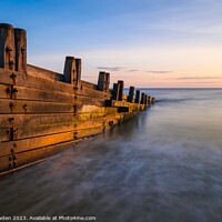 Buy canvas prints of Dawn's Embrace on Cromer Beach by Rick Bowden