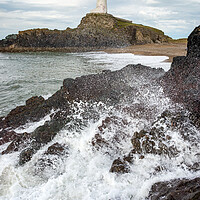 Buy canvas prints of Waves breaking below Twr Mawr lighthouse, Anglesey by Andrew Kearton