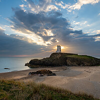 Buy canvas prints of Sun setting behind Twr Mawr Lighthouse, Wales by Andrew Kearton