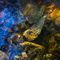 Buy canvas prints of Rocks below the water of a moorland stream by Andrew Kearton