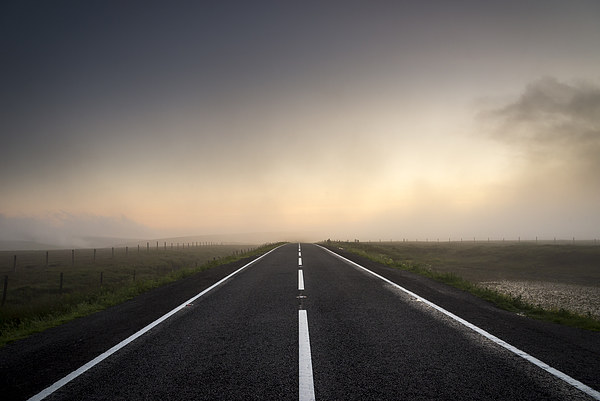  Road over the misty moors at sunset Picture Board by Andrew Kearton