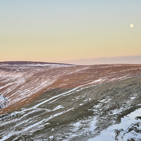 Buy canvas prints of  Moon rising above the snowy moors by Andrew Kearton