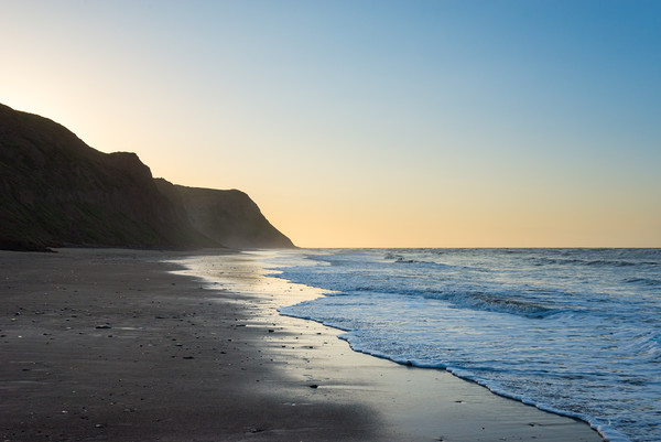 Cattersty Sands at dusk, North Yorkshire, England Picture Board by Andrew Kearton