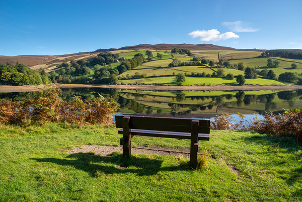 A wooden bench with views of Ladybower reservoir Picture Board by Andrew Kearton