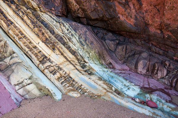 Colourful rocks at Marloes Sands, Pembrokeshire Picture Board by Andrew Kearton