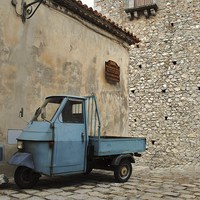 Buy canvas prints of Ancient Italian Piaggio parked by the bar ! by Kerry Goddard