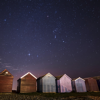 Buy canvas prints of Orion over beach huts by Chris Nesbit