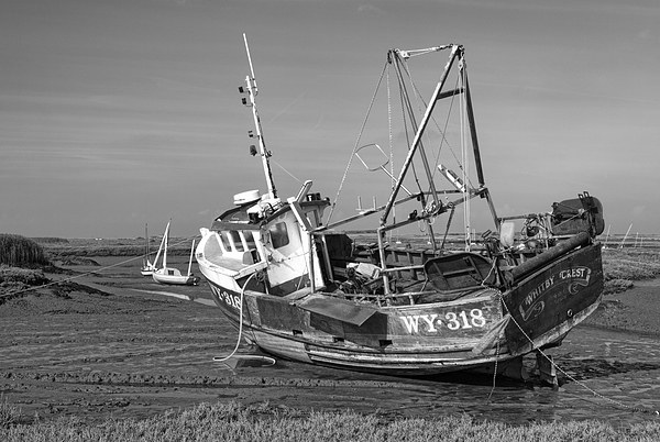 Monochrome of Whitby Crest at Brancaster Staithe Picture Board by John Edwards