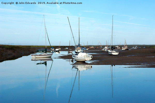 Reflections at Brancaster Staithe Picture Board by John Edwards