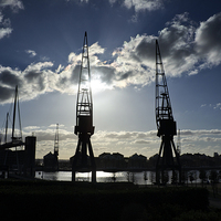 Buy canvas prints of London Docklands Cranes Silhouette.  by Peter Jones