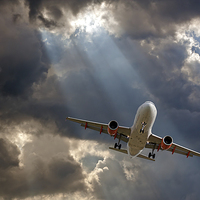 Buy canvas prints of Passenger plane on final approach, against a storm by ken biggs