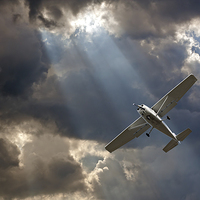 Buy canvas prints of Small fixed wing plane against a stormy sky by ken biggs
