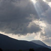 Buy canvas prints of Sun rays through storm clouds by ken biggs