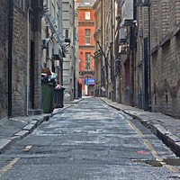 Buy canvas prints of Looking down an empty inner city alleyway by ken biggs