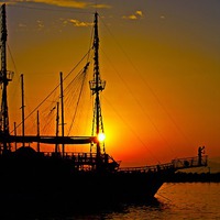 Buy canvas prints of a ship in silhouette at sunset  by ken biggs