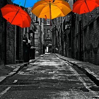 Buy canvas prints of  colorful umbrellas in a dark back street alley by ken biggs