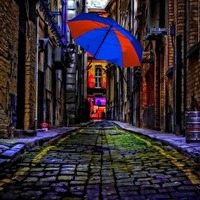 Buy canvas prints of colorful umbrella in a dark back street alley by ken biggs