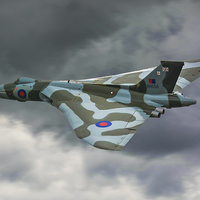 Buy canvas prints of  ARVO Vulcan XH558 flying low in moody skies over  by Andrew Scott