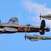 Buy canvas prints of Lancaster Bomber PA474 flanked by BBMF's Hurricane by Andrew Scott