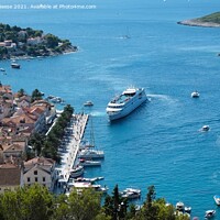Buy canvas prints of Liner docking at Hvar Harbour by Adrian Beese