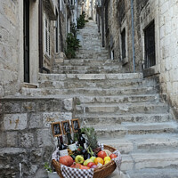 Buy canvas prints of Basket of wine and fruit in Dubrovnik by Adrian Beese