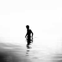 Buy canvas prints of Boy in the sea black and white version by DeniART 