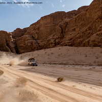 Buy canvas prints of Jeep speeding through Wadi Rum, Jordan by Jo Sowden