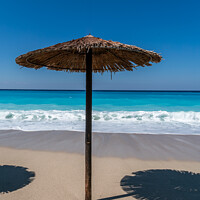 Buy canvas prints of A straw topped Beach Umbrella on Lefkada by Jo Sowden