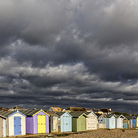 Buy canvas prints of Ferring Beach Huts Under a Brooding Sky by Len Brook