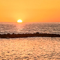 Buy canvas prints of Sunset over the rocky breaker by Naylor's Photography