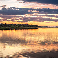 Buy canvas prints of Budle Bay Sunset at high tide  by Naylor's Photography