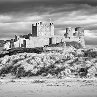 Buy canvas prints of Imposing Bamburgh Castle in Mono by Naylor's Photography