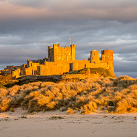 Buy canvas prints of Sun setting on Iconic Bamburgh Castle by Naylor's Photography
