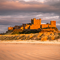 Buy canvas prints of Bamburgh Castle in the sunset  by Naylor's Photography