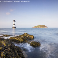 Buy canvas prints of Evening Light, Penmon Lighthouse, Anglesey by Colin & Linda McKie