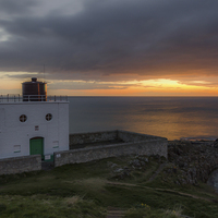 Buy canvas prints of  Sunrise at Bamburgh lighthouse by Phil Reay