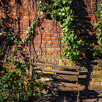 Buy canvas prints of Old Wooden Broken Bench By The Brick Wall by Artur Bogacki