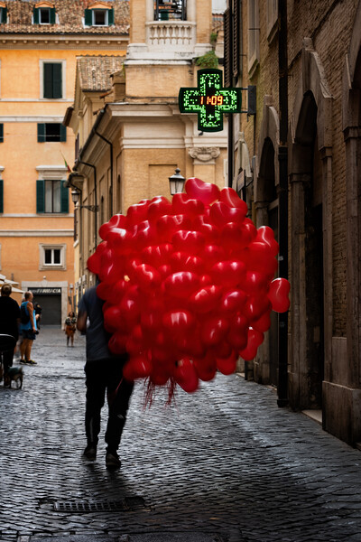 Men With Red Balloons On Cobblestone Street Picture Board by Artur Bogacki