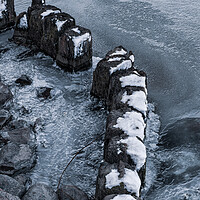 Buy canvas prints of Old Wooden Posts In Frozen River by Artur Bogacki