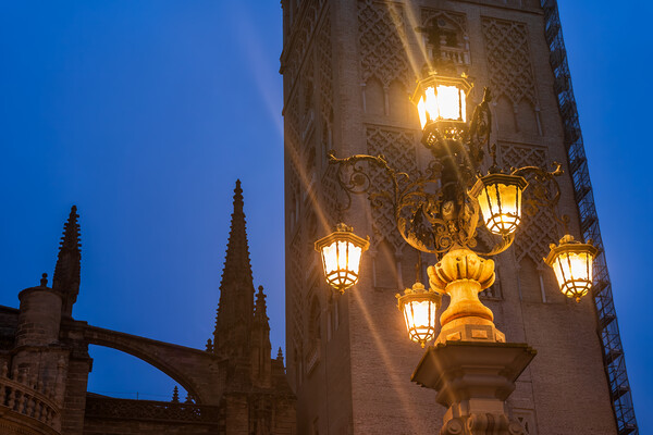Fuente De La Farola Lamp Against Giralda Tower In Seville Picture Board by Artur Bogacki