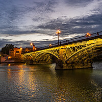 Buy canvas prints of Evening at Triana Bridge in Seville by Artur Bogacki
