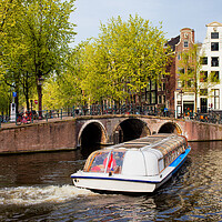 Buy canvas prints of Canal Boat in Amsterdam by Artur Bogacki