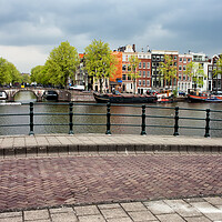 Buy canvas prints of Houses by the Amstel River in Amsterdam by Artur Bogacki