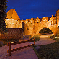 Buy canvas prints of Teutonic Knights Castle at Night in Torun by Artur Bogacki