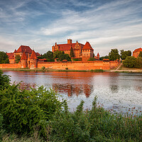 Buy canvas prints of Malbork Castle in Poland at Sunset by Artur Bogacki