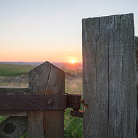 Buy canvas prints of Sunset taken through gate post by David Graham