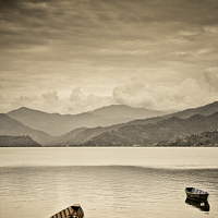 Buy canvas prints of  Lone boats on Fewa Lake, Pokhara, Nepal by Julian Bound